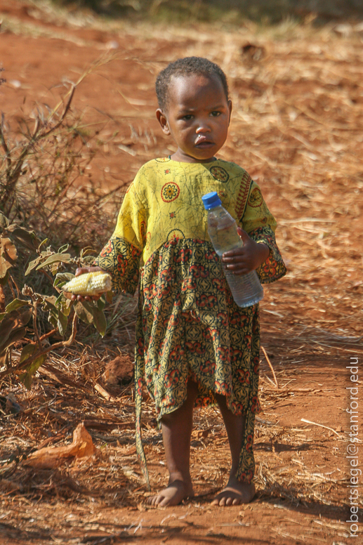 Young girl with water bottle and corn